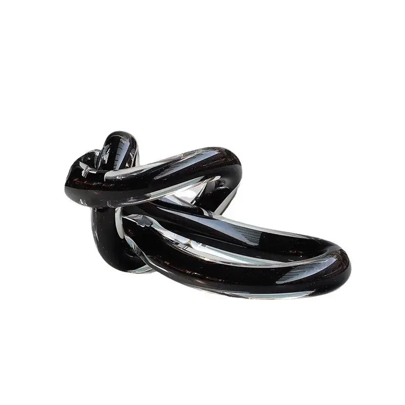 A sleek glossy black glass twine knot sculpture with smooth curves for home decor by decorbites geometric glass