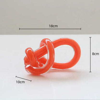 Vibrant orange glass twine knot sculpture with smooth glossy finish and transparent sections for home decor by decorbites geometric glass
