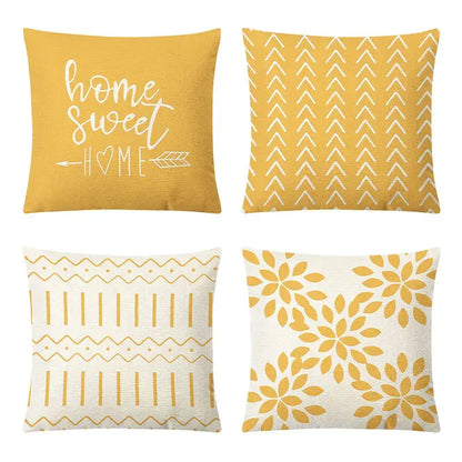 Set of four mustard-yellow and cream geometric yellow linen pillow covers with embroidered home sweet home and floral decorbites designs