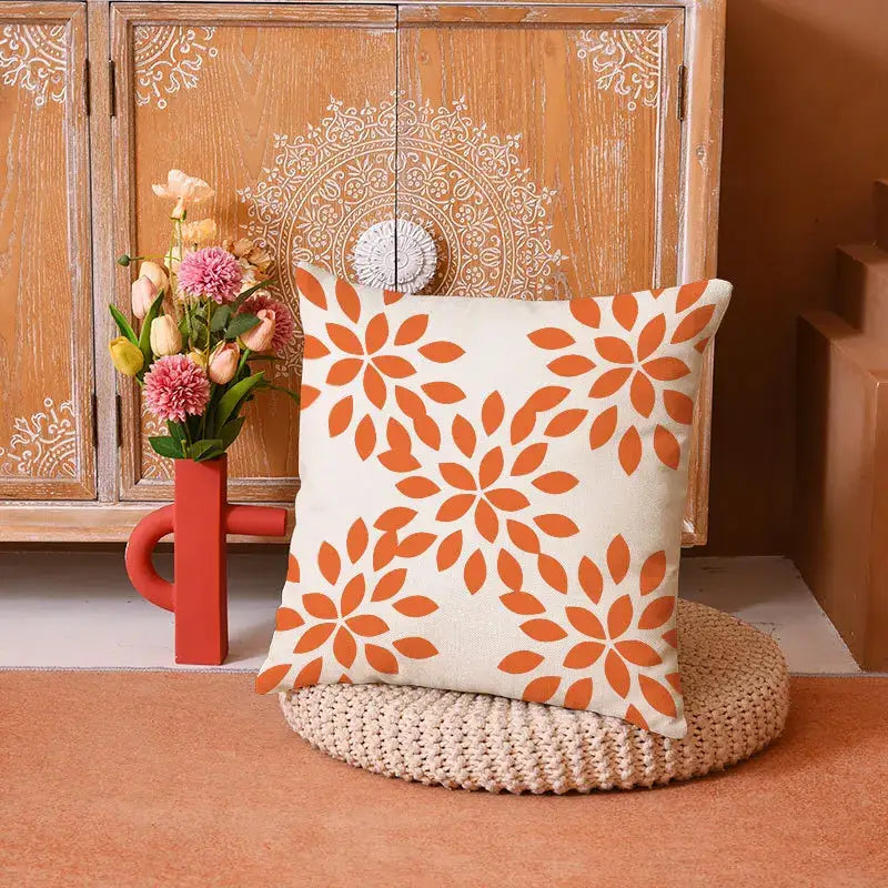 Cream-colored pillow cover featuring a repeating orange stylized flower pattern in decorbites geometric yellow linen set