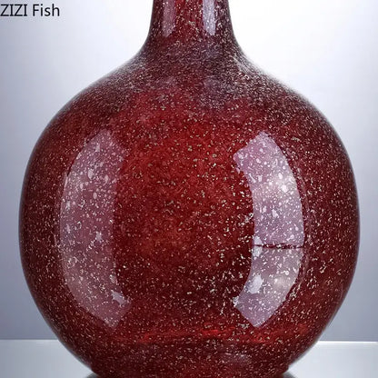 A gilded red glass vase with speckled texture and artificial flowers for decorbites gilded red desk decor
