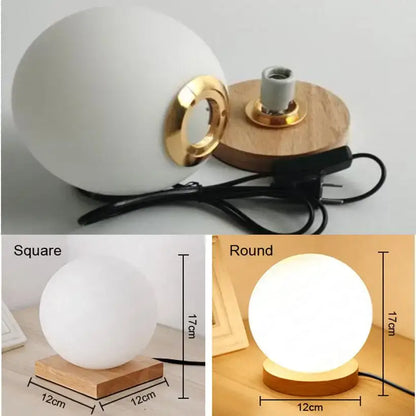 Glass ball led table lamp with a white matte spherical lamp, gold-toned ring, and wooden base for bedroom night light decorbites glass ball