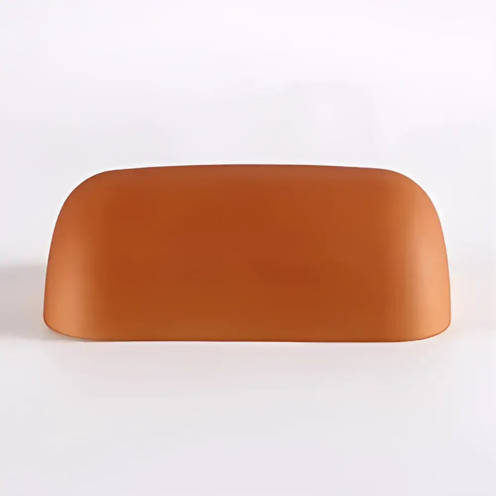 A smooth matte terracotta ceramic headrest shown with decorbites glass banker lamp shade for desk or office in 4 colors