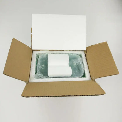 White rectangular electronic device nestled in foam inside a box for decorbites glass banker lamp shade product