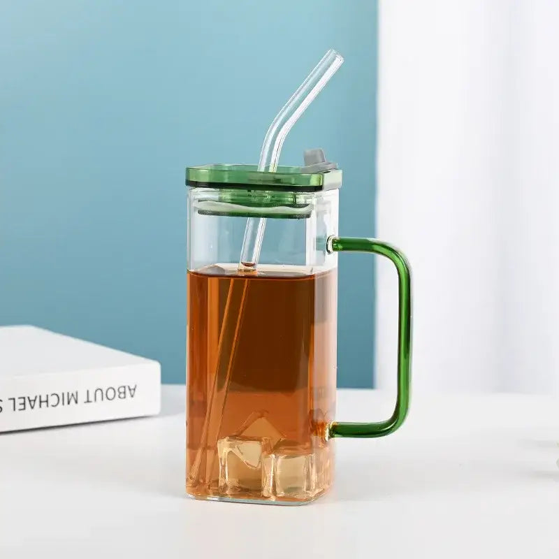 Clear glass drinking cup with green handle and lid featuring integrated straw from decorbites glass drinking cups