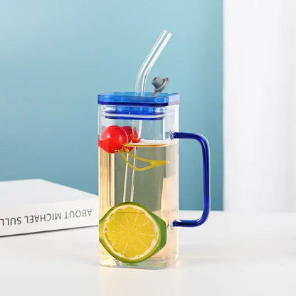 Clear glass drinking cup with blue lid handle and straw filled with lemon water and cherries decorbites glass drinking cups
