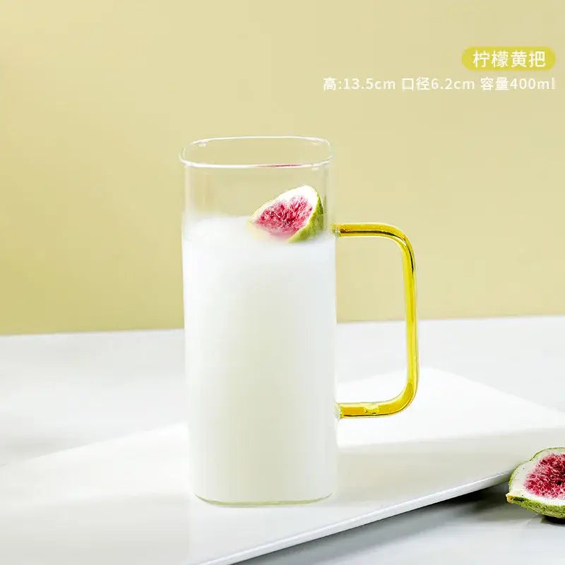 Clear glass drinking cups with golden handles filled with white liquid and fig slice by decorbites glass drinking cups