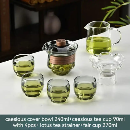 Clear glass gaiwan cup set with wooden lid and copper band includes green cups pitcher and lotus tea filter for dining room