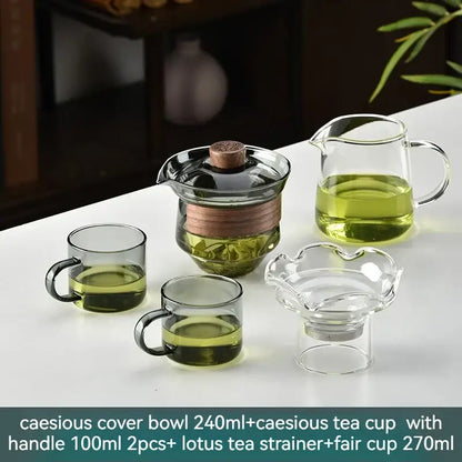 Clear glass gaiwan cup set with wooden lid and copper band includes matching cups and tea strainers for dining room use