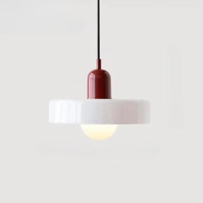 Minimalist glass pendant lighting with a glossy red cylindrical base and white ribbed circular shade in Bauhaus style
