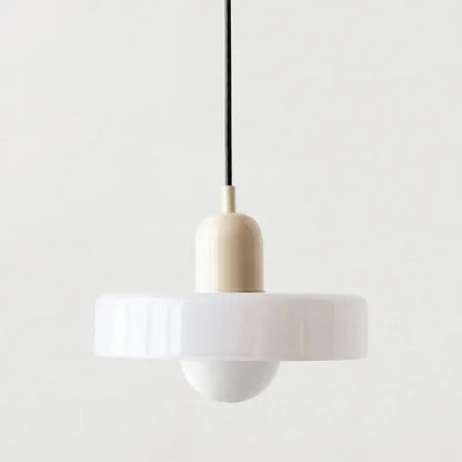 Minimalist white glass pendant lighting with a sleek ribbed circular shade and cream cylindrical base bauhaus style