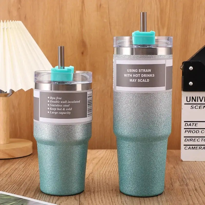 Two teal glitter finish stainless steel double wall insulated tumblers with matching turquoise straw caps and metal straws