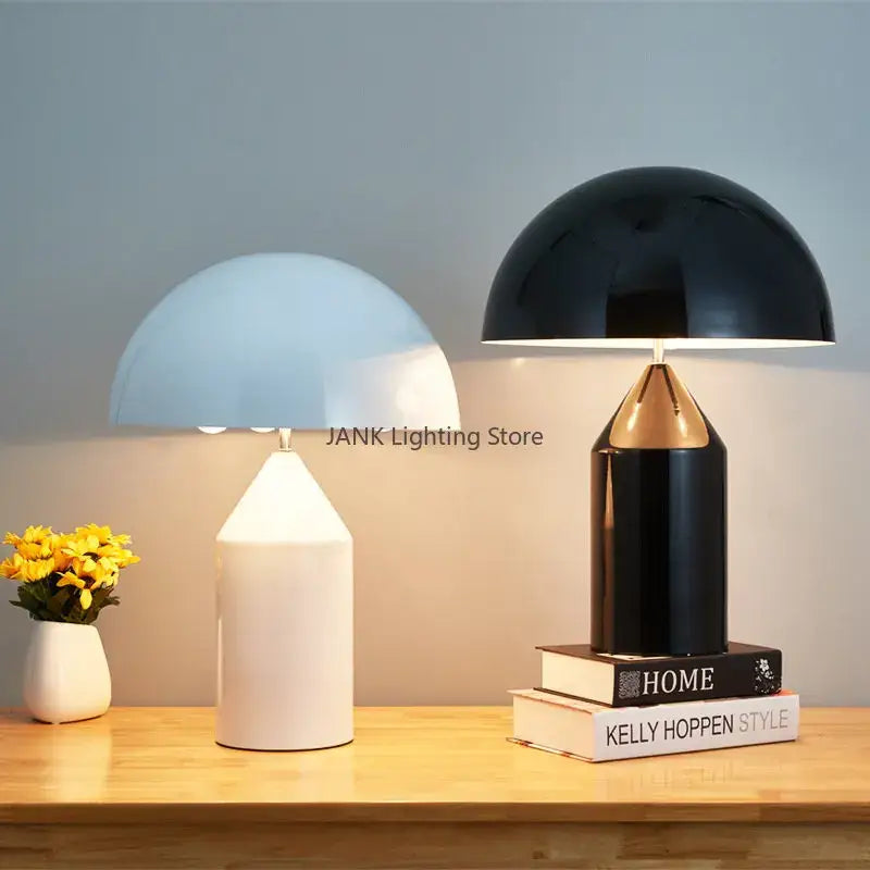 Glossy black and gold metal mushroom table lamp with a dome-shaped shade and pencil base for decorbites atollo bedroom