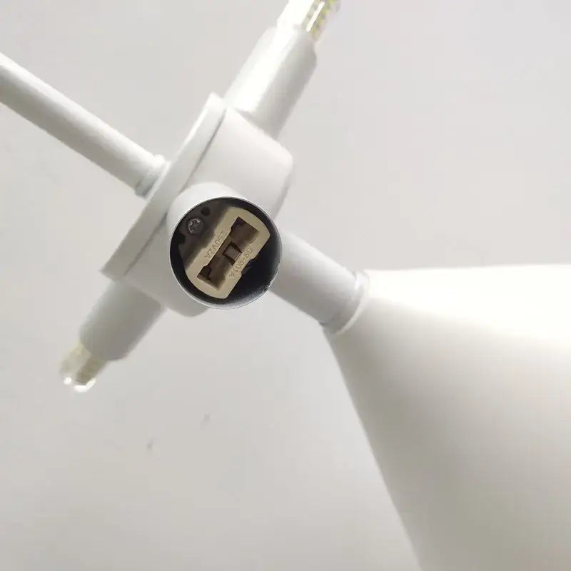 White plastic usb charging port with circular black cover and contacts on the back of atollo black white mushroom lamp