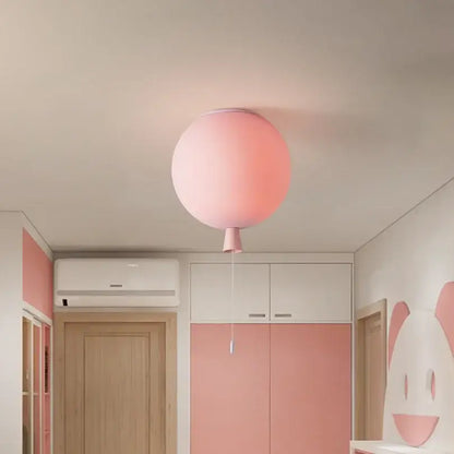 A soft pink balloon ceiling lamp with a subtle gradient and matching pull cord for kids bedroom ceiling light