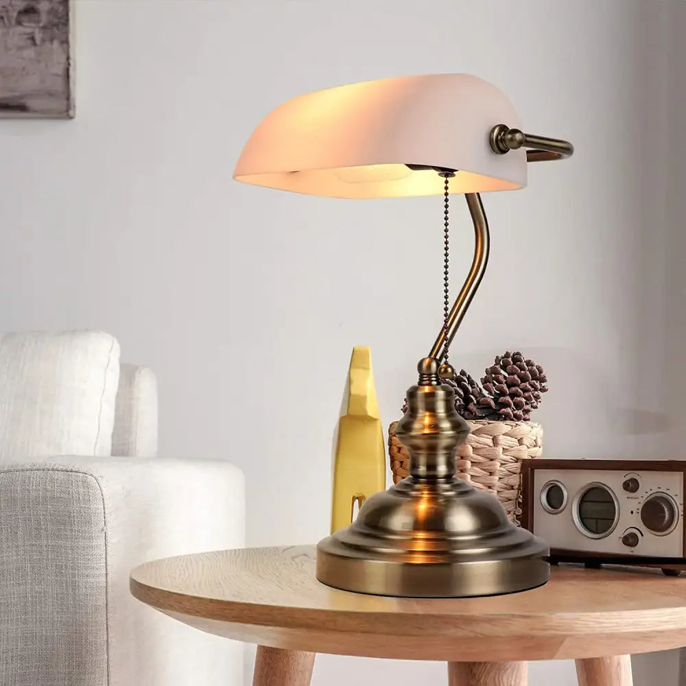 Antique brass-finished desk lamp with soft frosted glass shade featuring decorbites glass banker lamp cover in green and amber