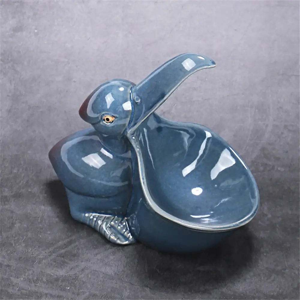 Glossy blue ceramic animal storage pelican dish with detailed feet from decorbites ceramic animal kitchen collection