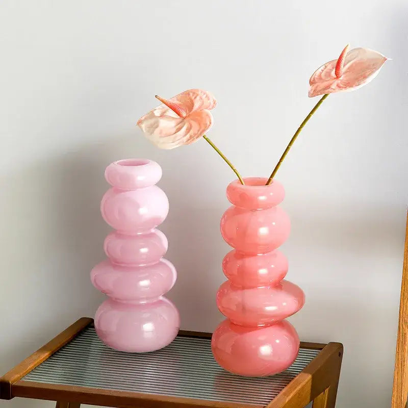 Glossy pastel pink glass vase with stacked bubble pebble stack floral design for living room arrangement