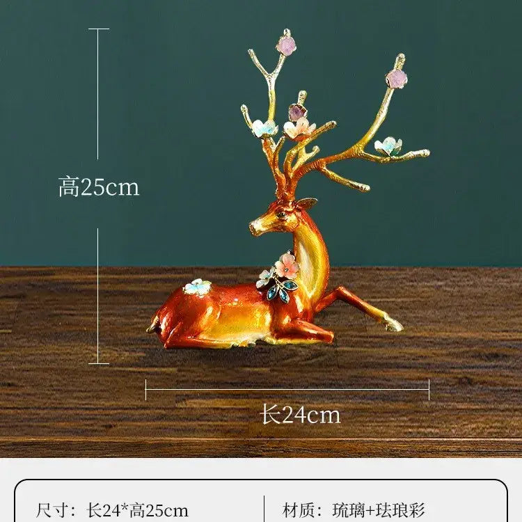 A glossy reddish brown and white glass and resin deer figurine with floral antlers in a peace porch decoration set