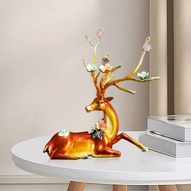 Golden deer figurine with intricate antlers and gemstone blossoms in a glossy reddish brown and white deer peace porch decoration set on white table