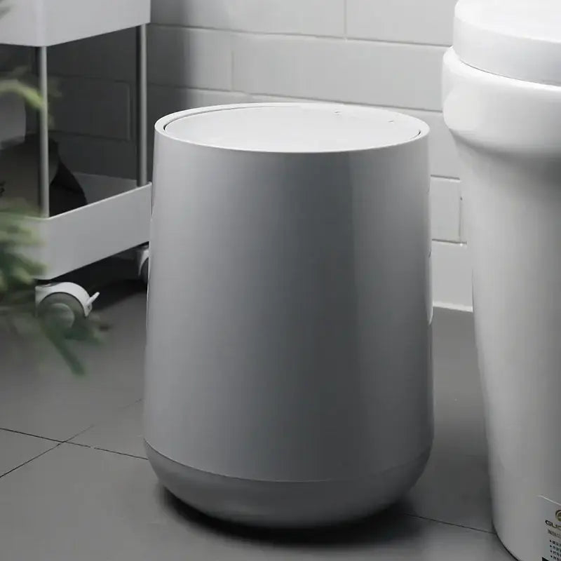 A sleek gray cylindrical waste bin with matte finish for garbage classification in decorbites kitchen bathroom use
