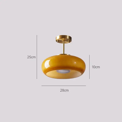 A sleek amber glass led pendant light with brass finish perfect for kitchen or dining room pendant lights