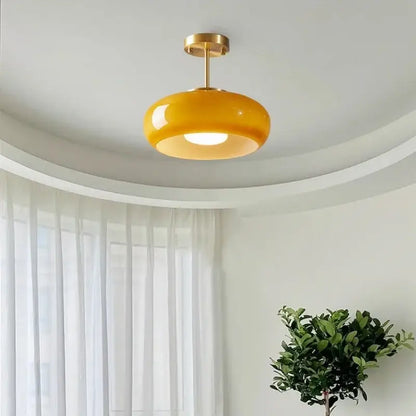 Glossy yellow glass ball led pendant light with polished brass fixture ideal for kitchen or dining room pendant lights