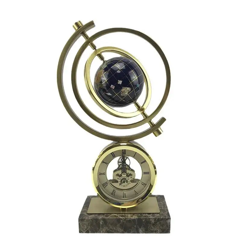 Gold and blue clock globe decoration with dark blue grid-patterned sphere and roman numeral dial on marble base
