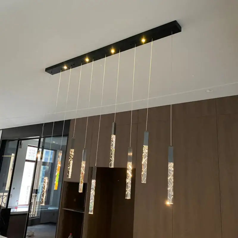 Modern black rectangular decorbites crystal led chandelier with five glowing cylindrical pendant lights for staircase decor