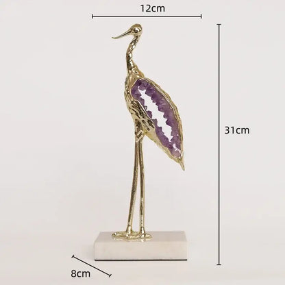 Elegant gold and emerald crystal crane sculpture with purple amethyst geode wing on white marble base for living room decor