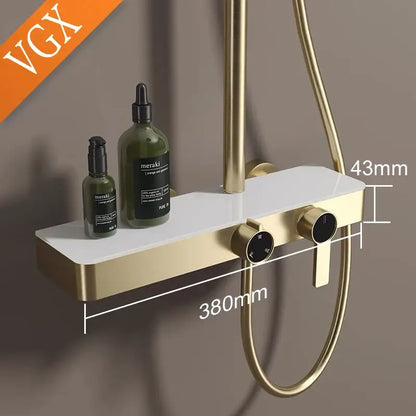Gold and marble bathroom shower set with gold-finished shower tray white ceramic surface and temperature control knobs