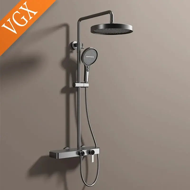 Modern matte black bathroom shower set with round rainhead handheld spray and sleek chrome accents and marble shelf