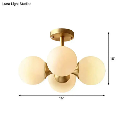 Gold-toned semi-flush mount ceiling fixture with four frosted opaline glass globes for 220v-240v 110v-120v use