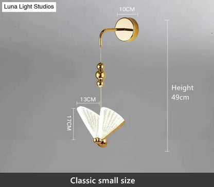 Gold finished nordic butterfly led wall light with fan shaped translucent shade and decorative spherical beads for bedroom