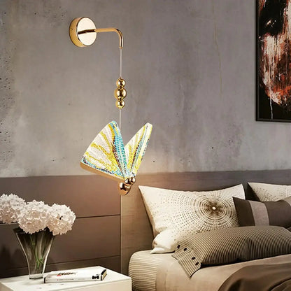 Gold and patterned butterfly led wall light featuring a gold-toned sconce with intricate yellow blue white lampshade