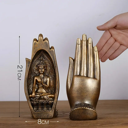 Gold and silver buddha hands monk figurine decor featuring a golden buddha statue nestled in hand-shaped bookend