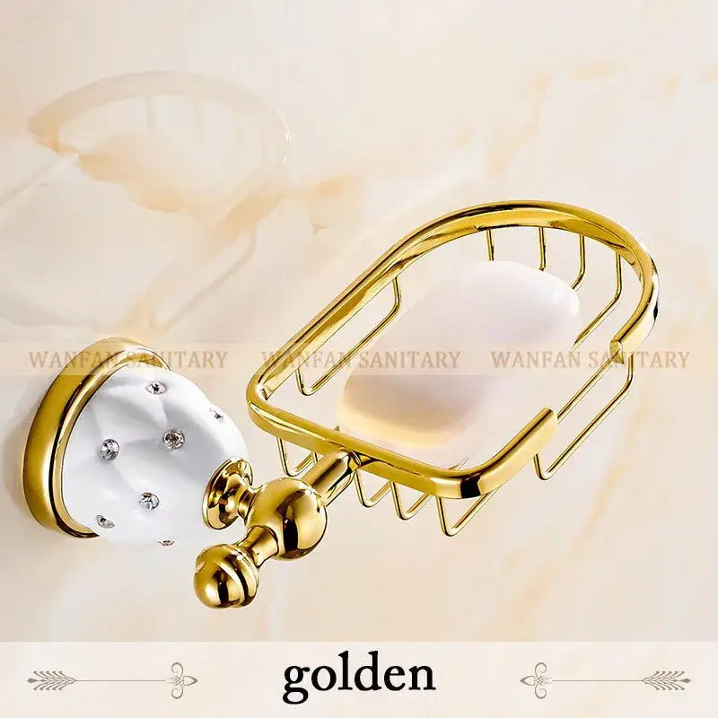 Gold-finished metal soap dish with white ceramic and crystal accents in a bath hardware set for bathroom accessories