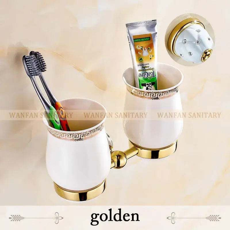 White ceramic toothbrush holder with gold accents and greek key trim from gold and white crystal bath hardware set