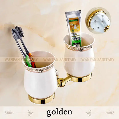 White ceramic toothbrush holder with gold accents and greek key trim from gold and white crystal bath hardware set