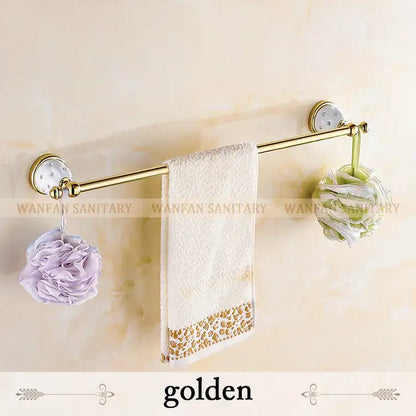 Gold and white crystal bath hardware set with golden towel rack, ceramic wall mounts, and white towel with gold trim