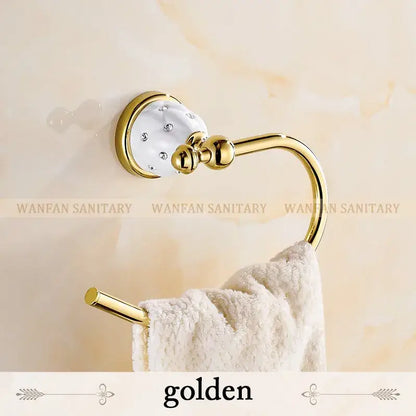 Golden towel ring with white ceramic head and clear crystals in polished brass finish for bath hardware set