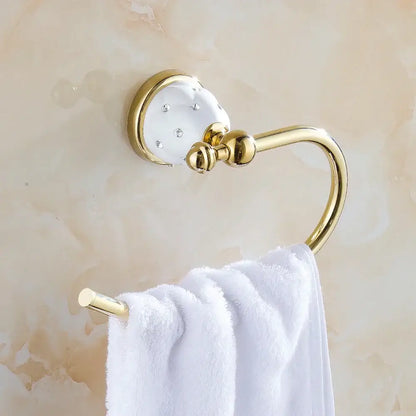 Gold and white crystal bath hardware set featuring a gold-toned towel rack with clear rhinestones and a white towel