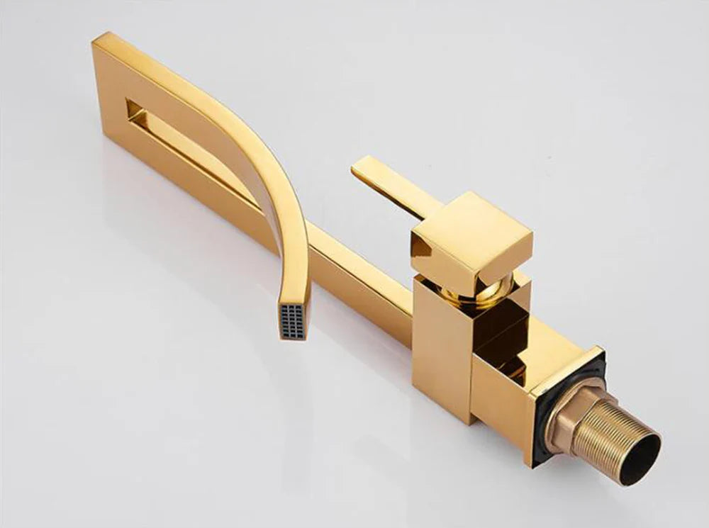Gold-colored modern single hole deck mounted bathroom basin faucet with sleek angular design and rectangular spout