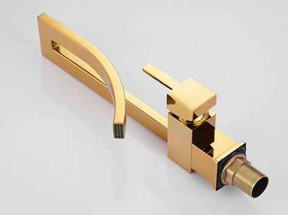 Gold-colored modern single hole deck mounted bathroom basin faucet with sleek angular design and rectangular spout
