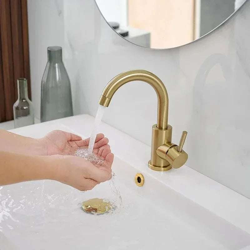 Brass-finished gold bathroom faucet with curved spout single handle made of modern stainless steel material