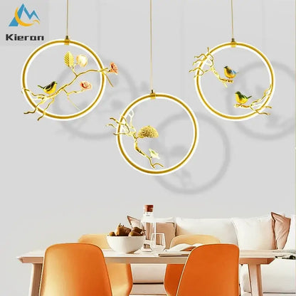 Gold bird led chandelier featuring gold-toned circular pendant lights with intricate bird and floral decorbites bird design