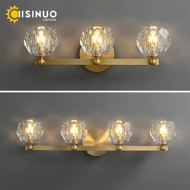 Gold-toned brass vanity light fixture with three faceted crystal shades for bathroom vanity light fixtures