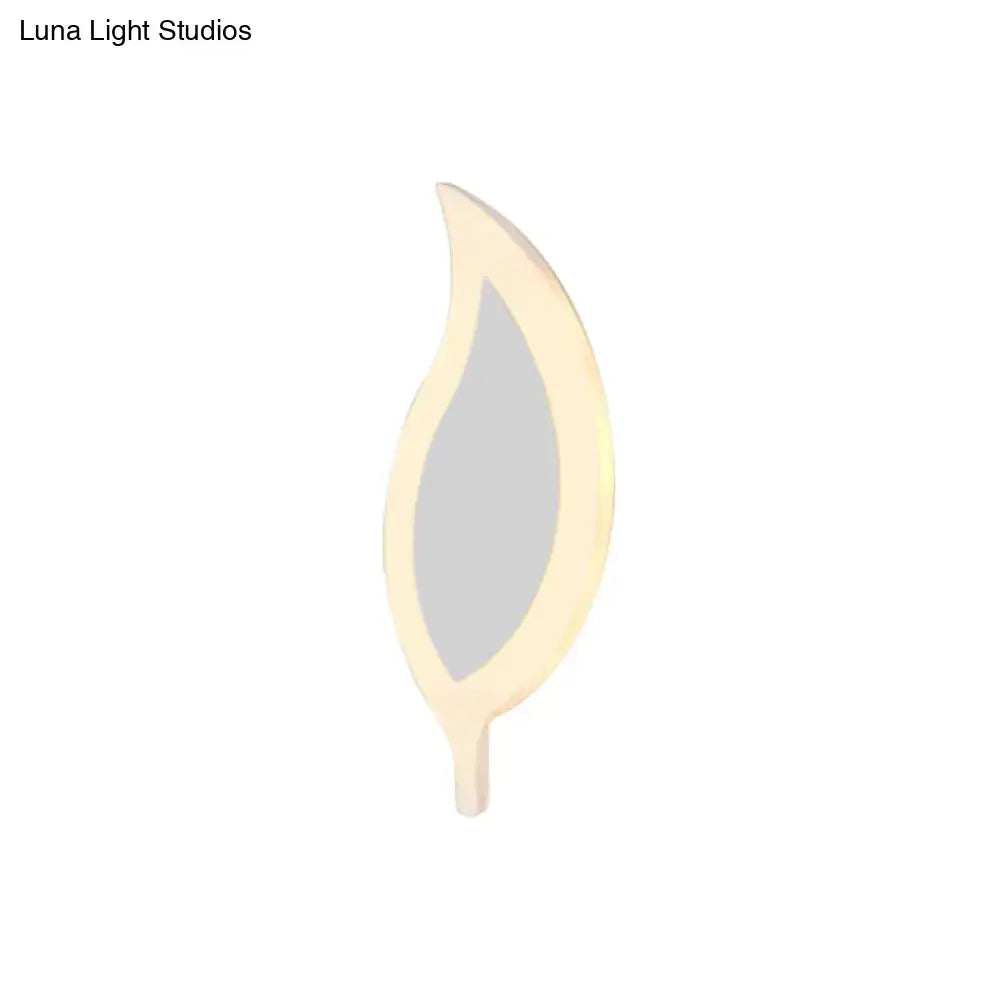 A sleek cream-colored leaf-shaped wall light with a modern finish for children’s bedroom wall lights