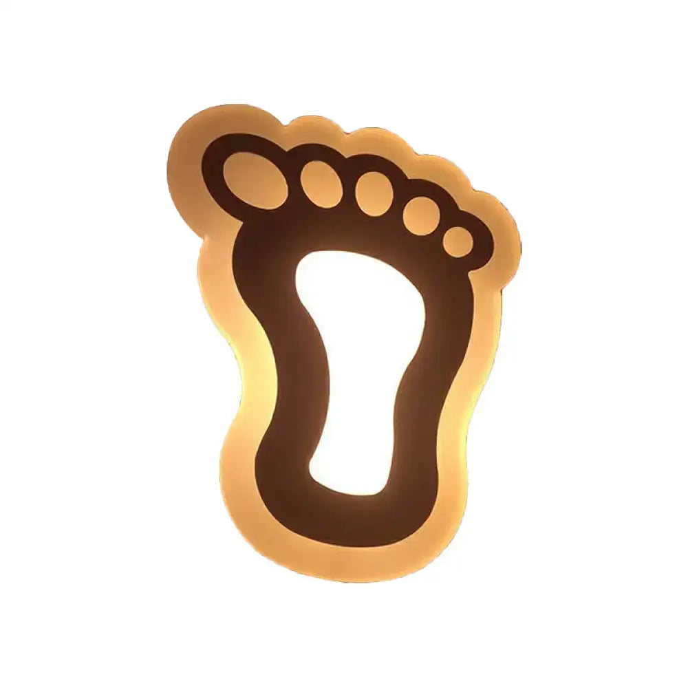 A warm gold and brown crescent led wall light with a glowing foot shape for children’s bedroom wall lights