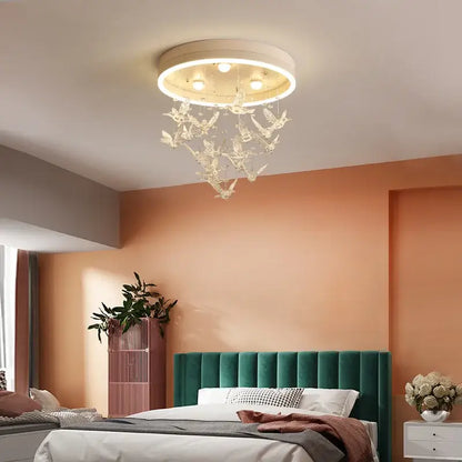 A gold butterfly crystal led ceiling lamp with a white circular base and translucent bird ornaments for kids bedroom decorbites crystal led